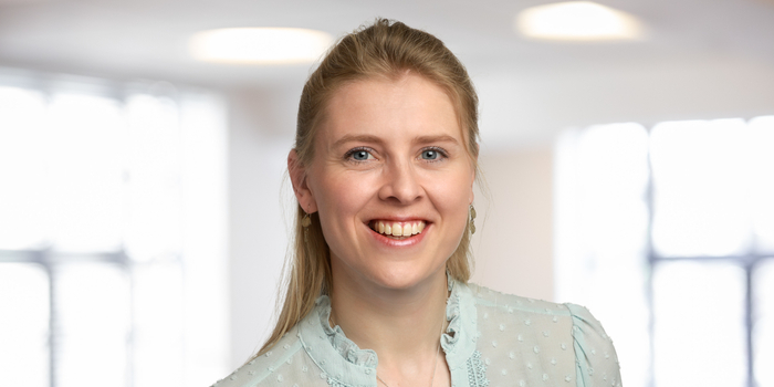 A young businesswoman smiles at the camera